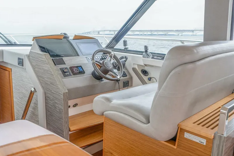  Yacht Photos Pics 2021 Tiara Yachts F44 Flybridge helm with modern controls and comfortable seating.