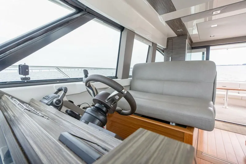  Yacht Photos Pics 2021 Tiara Yachts F44 Flybridge helm with modern controls and seating.