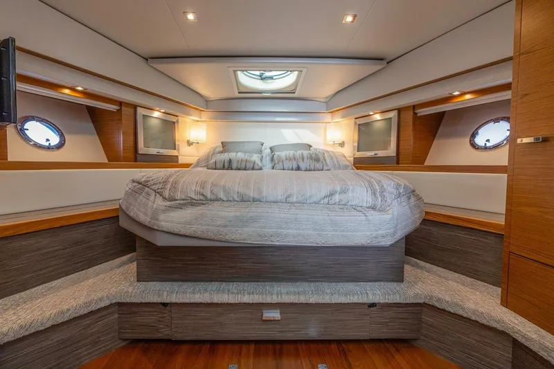  Yacht Photos Pics Luxurious bedroom interior of 2021 Tiara Yachts F44 Flybridge with modern design and cozy bedding.