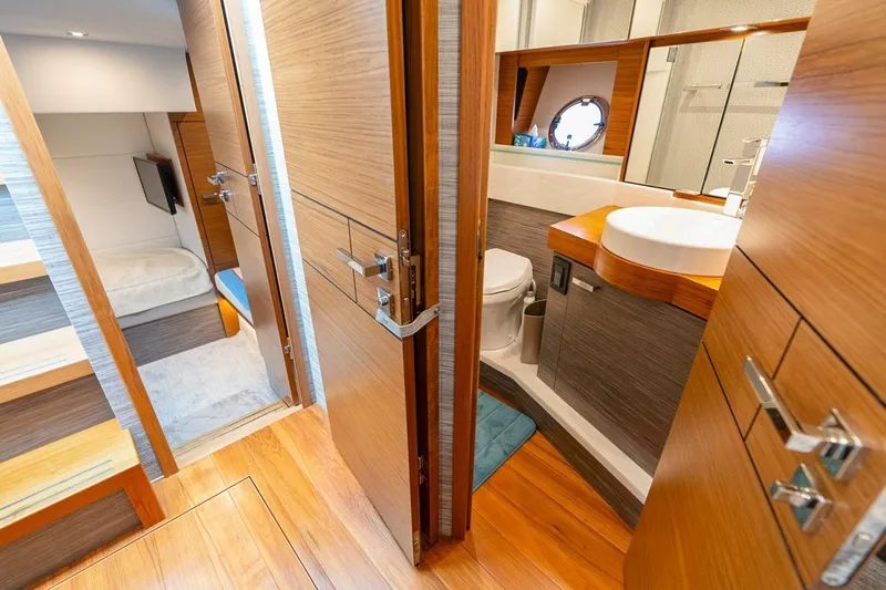  Yacht Photos Pics Luxurious interior of 2021 Tiara Yachts F44 Flybridge, featuring a modern bathroom and cozy cabin.