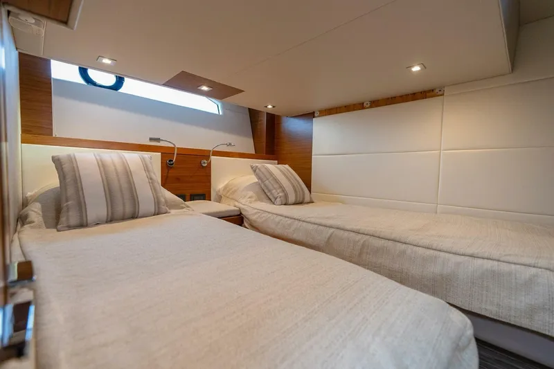  Yacht Photos Pics 2021 Tiara Yachts F44 Flybridge cabin with twin beds and modern decor.
