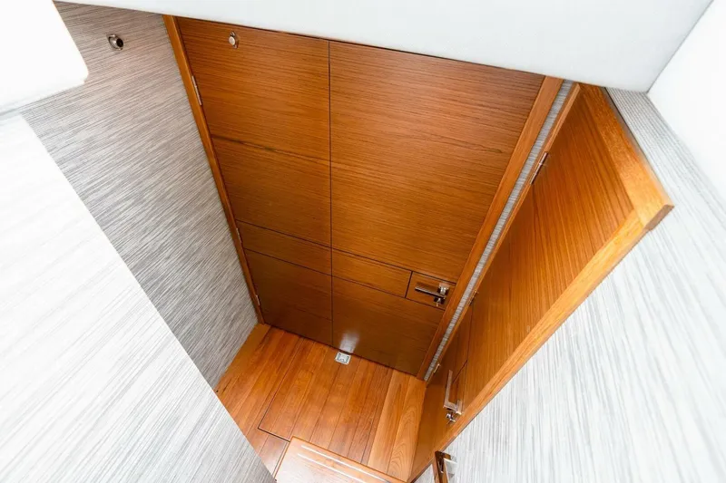  Yacht Photos Pics 2021 Tiara Yachts F44 Flybridge interior with wooden door and flooring.