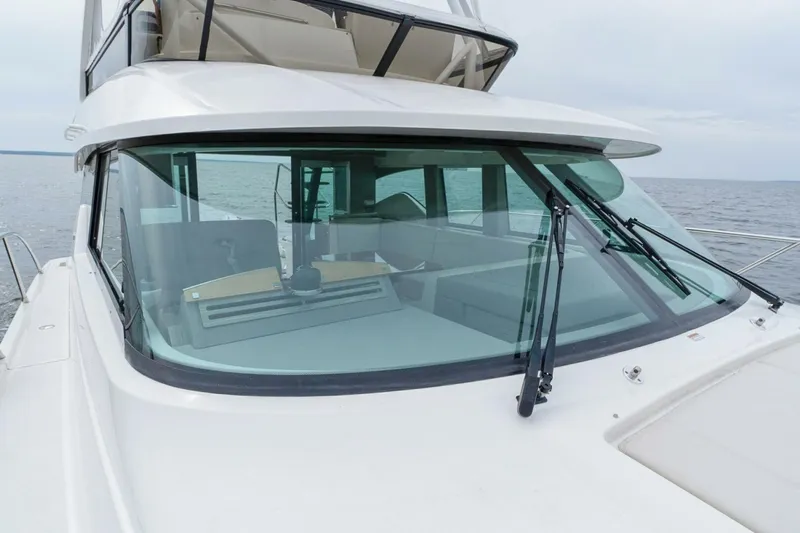  Yacht Photos Pics 2021 Tiara Yachts F44 Flybridge on open water, showcasing sleek design and windshield.