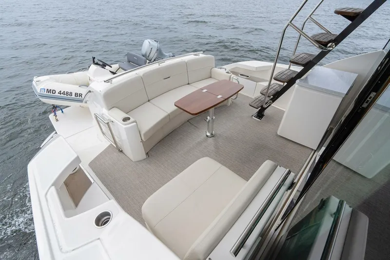  Yacht Photos Pics 2021 Tiara Yachts F44 Flybridge with spacious deck and seating area on the water.