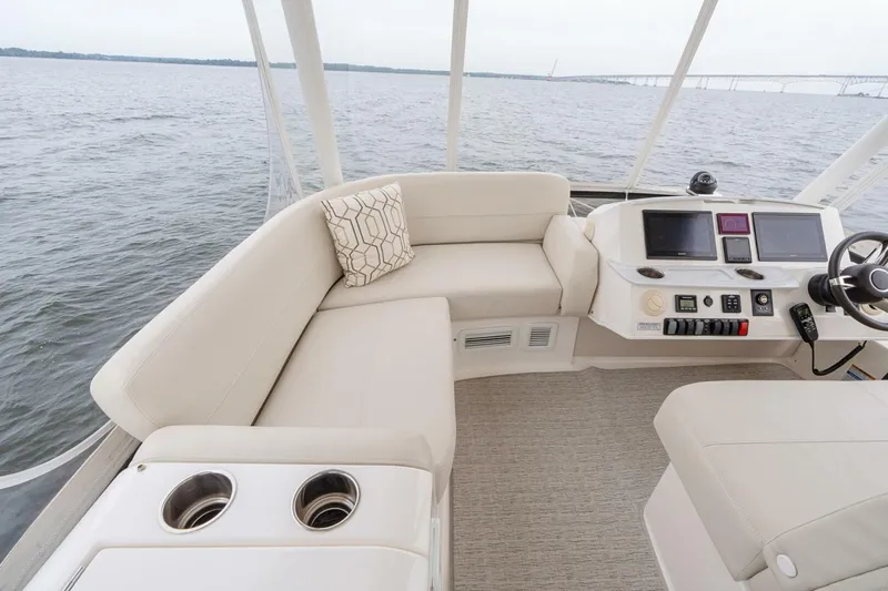  Yacht Photos Pics Flybridge of 2021 Tiara Yachts F44, featuring plush seating and modern navigation controls.