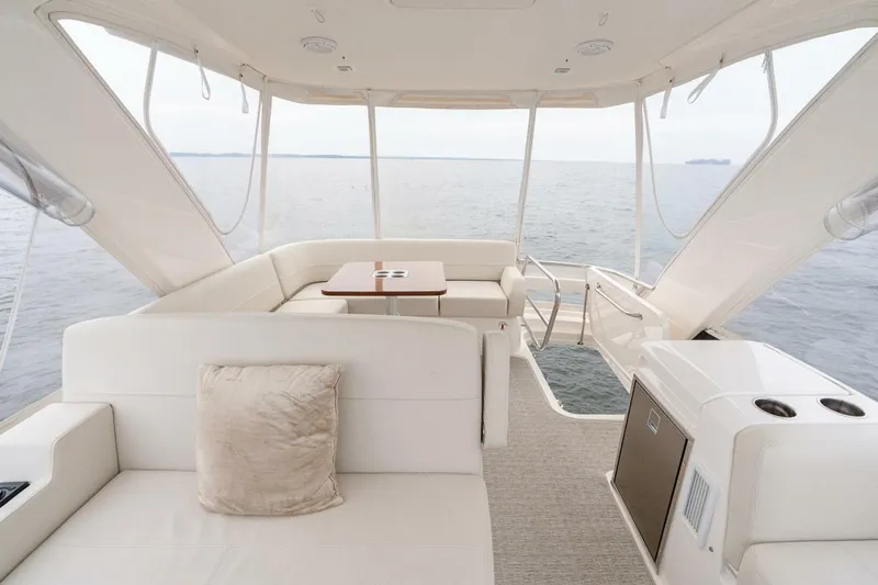  Yacht Photos Pics Luxurious 2021 Tiara Yachts F44 Flybridge interior with ocean view, featuring elegant seating.