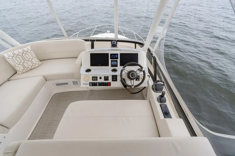  Yacht Photos Pics 2021 Tiara Yachts F44 Flybridge helm with modern controls and plush seating.
