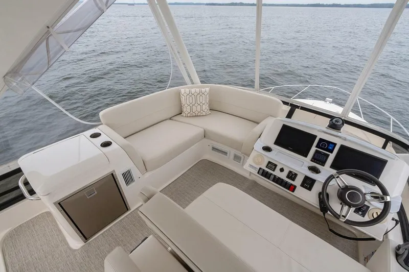  Yacht Photos Pics 2021 Tiara Yachts F44 Flybridge interior with helm, seating, and water view.