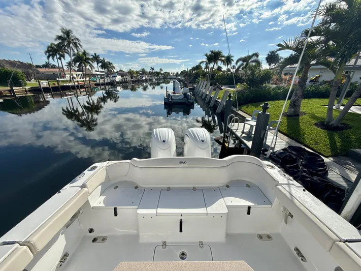  Yacht Photos Pics 2024 Sea Hunt Ultra 275 SE boat docked on a scenic, palm-lined canal.