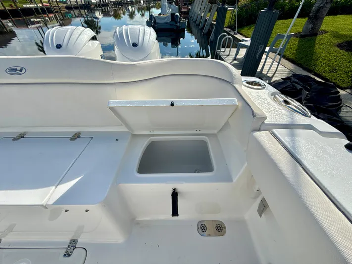  Yacht Photos Pics 2024 Sea Hunt Ultra 275 SE boat interior with open storage compartment.