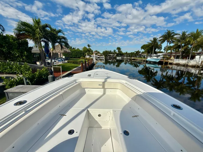  Yacht Photos Pics 2024 Sea Hunt Ultra 275 SE boat docked in a scenic, tropical canal setting.