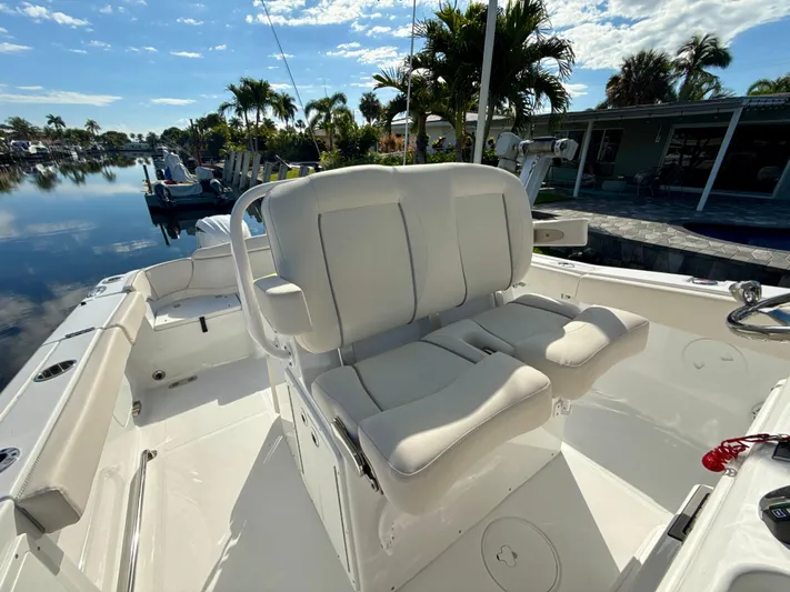  Yacht Photos Pics 2024 Sea Hunt Ultra 275 SE boat interior with comfortable seating and scenic waterfront view.