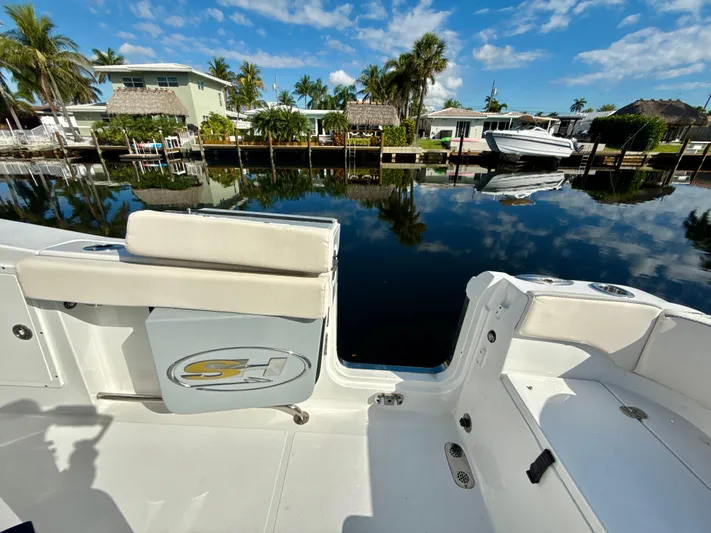  Yacht Photos Pics 2024 Sea Hunt Ultra 275 SE boat docked by a scenic waterfront.