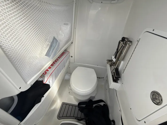 Yacht Photos Pics 2024 Sea Hunt Ultra 275 SE boat interior with toilet and storage area.