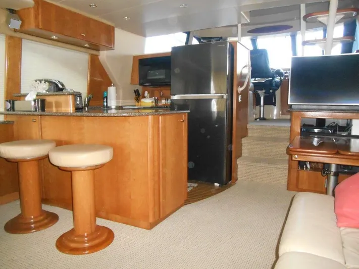  Yacht Photos Pics Interior of 2004 Meridian 540 Pilothouse yacht with kitchen and seating area.