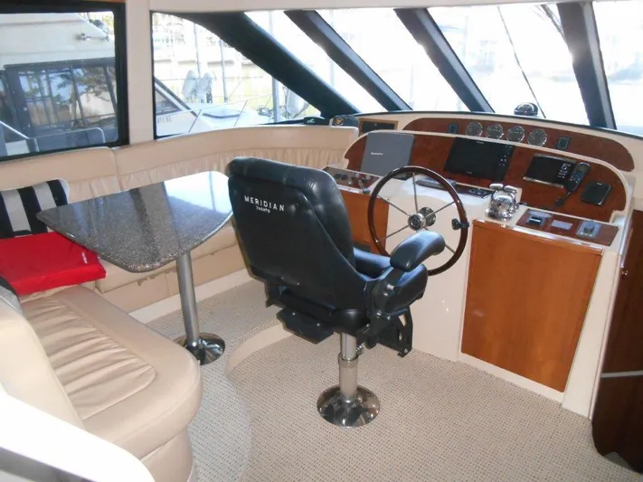  Yacht Photos Pics Interior of 2004 Meridian 540 Pilothouse with helm, seating, and table.