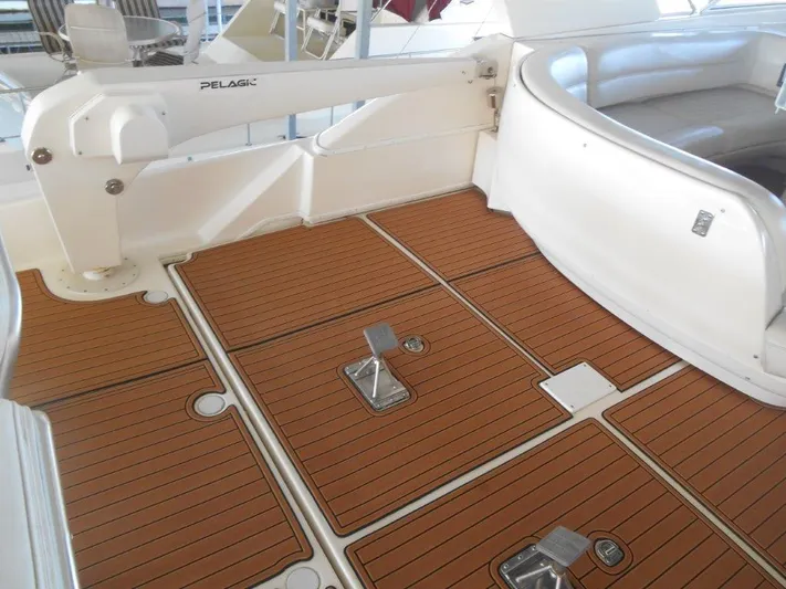  Yacht Photos Pics Meridian 540 Pilothouse 2004 boat deck with teak flooring and seating area.