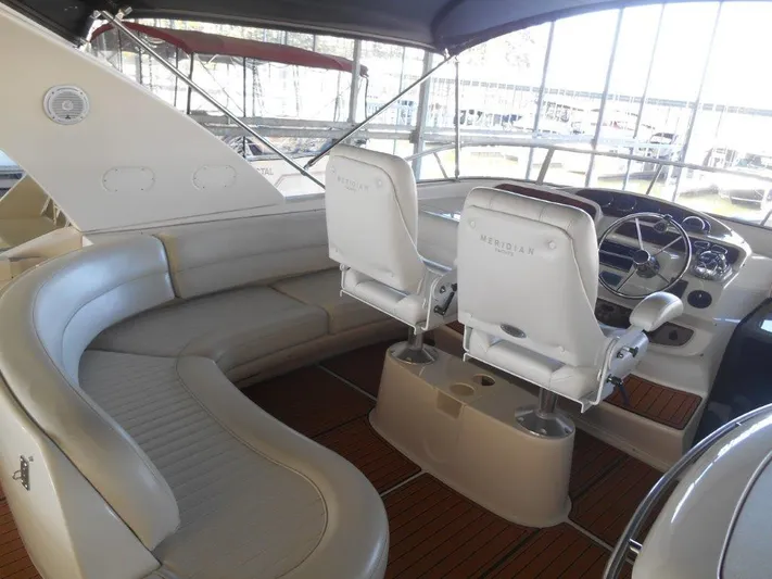  Yacht Photos Pics Interior of 2004 Meridian 540 Pilothouse yacht with plush seating and modern helm.