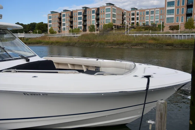  Yacht Photos Pics Boston Whaler 350 Realm 2020 docked near modern waterfront buildings.