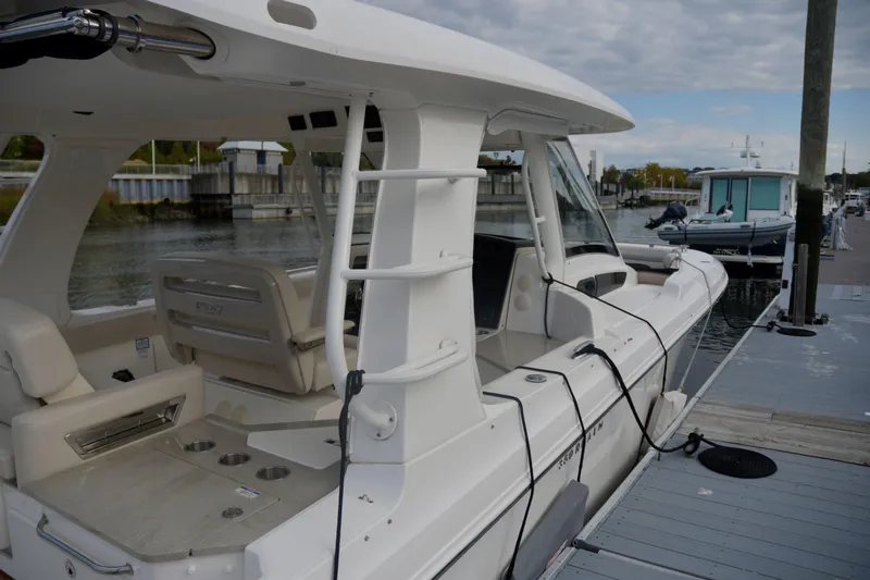  Yacht Photos Pics 2020 Boston Whaler 350 Realm docked at marina, showcasing sleek design and spacious interior.