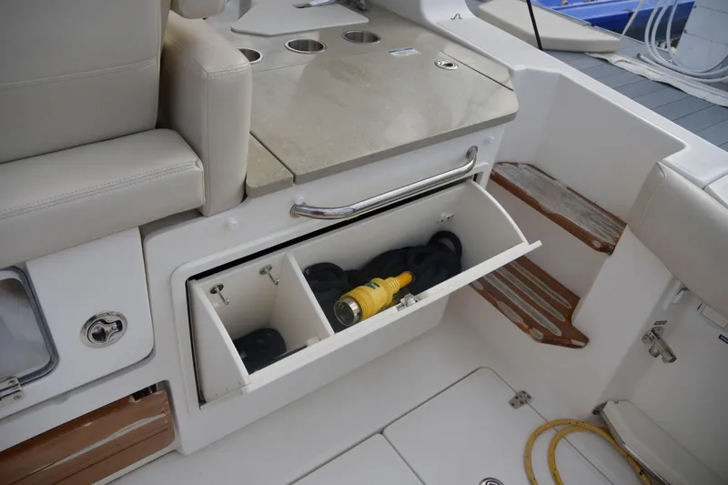  Yacht Photos Pics 2020 Boston Whaler 350 Realm interior storage compartment with tools and accessories.