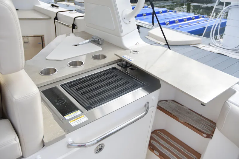  Yacht Photos Pics 2020 Boston Whaler 350 Realm boat grill and seating area.