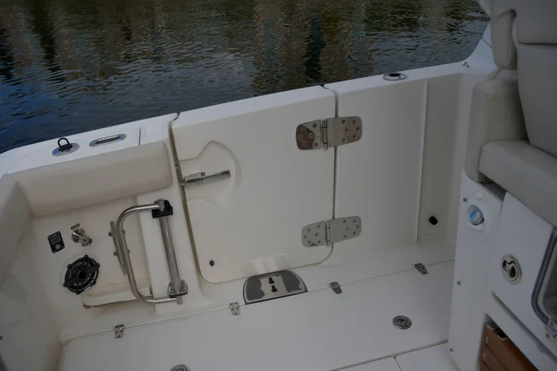  Yacht Photos Pics 2020 Boston Whaler 350 Realm boat interior, featuring a sleek, white deck and secure fittings.