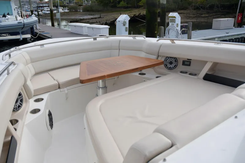  Yacht Photos Pics Boston Whaler 350 Realm 2020 boat interior with seating and wooden table.