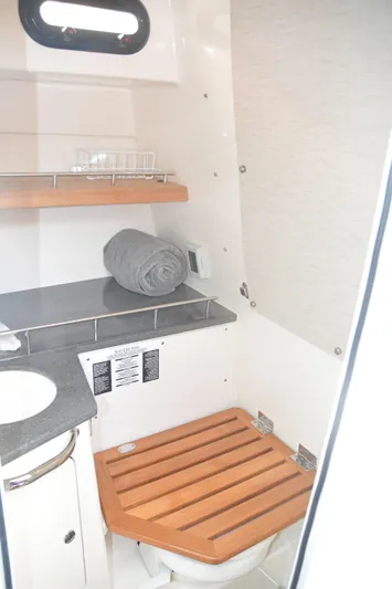  Yacht Photos Pics 2020 Boston Whaler 350 Realm bathroom with wooden seat and modern amenities.