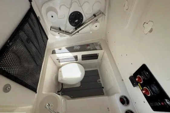 242-934 Yacht Photos Pics 2024 Sailfish 242 CC boat interior with compact marine toilet and storage features.