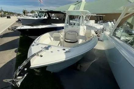 242-934 Yacht Photos Pics 2024 Sailfish 242 CC boat displayed at a marina, showcasing sleek design and modern features.