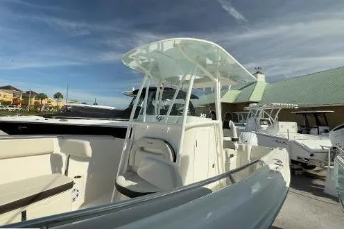 242-934 Yacht Photos Pics 2024 Sailfish 242 CC boat with sleek design and spacious deck in marina setting.
