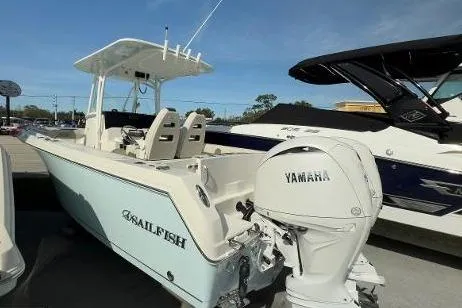 242-934 Yacht Photos Pics 2024 Sailfish 242 CC boat with Yamaha engine, docked outdoors under clear sky.