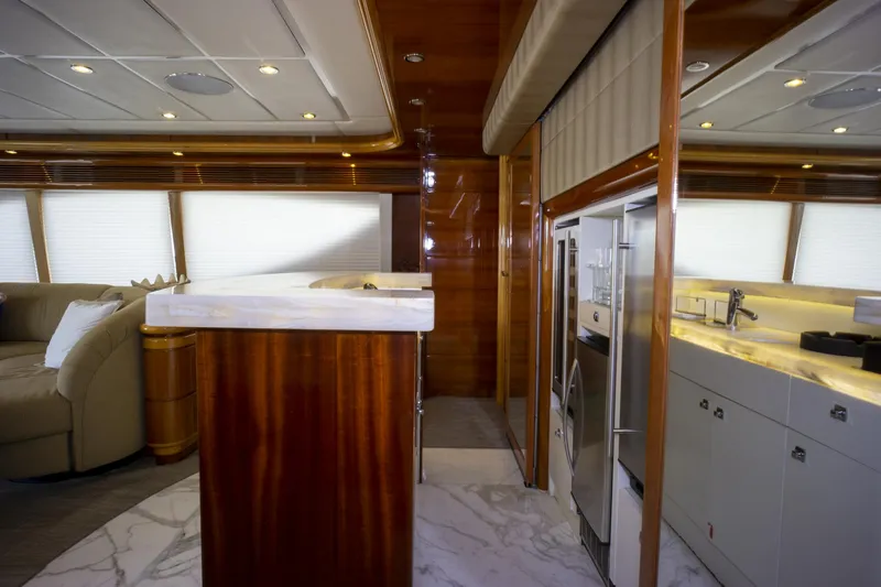 Paladin Yacht Photos Pics Luxurious interior of 2000 Ferretti Yachts Custom Line 94 with modern kitchen and seating area.