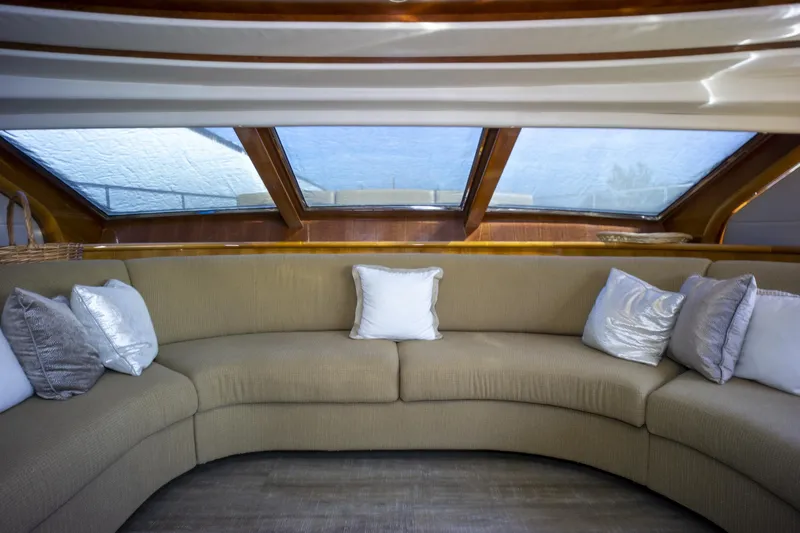 Paladin Yacht Photos Pics Luxurious interior of 2000 Ferretti Yachts Custom Line 94 with plush seating and large windows.
