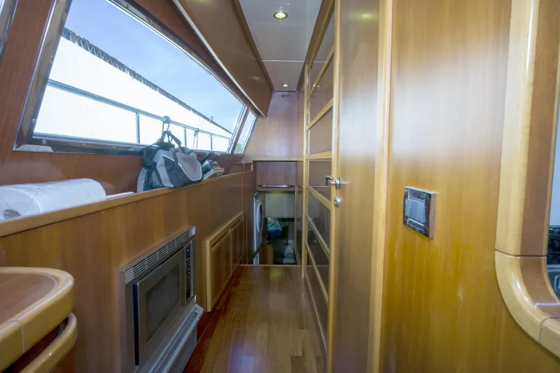 Paladin Yacht Photos Pics Interior of 2000 Ferretti Yachts Custom Line 94 with wood paneling and modern design.