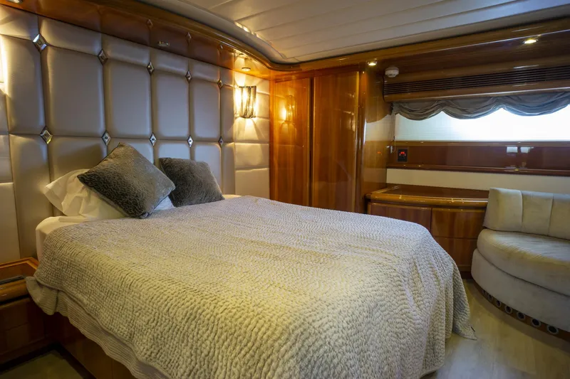 Paladin Yacht Photos Pics Luxurious bedroom interior on 2000 Ferretti Yachts Custom Line 94, featuring elegant wood paneling.