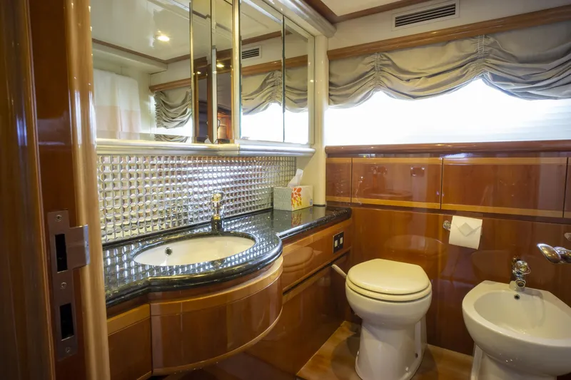 Paladin Yacht Photos Pics Luxurious bathroom in 2000 Ferretti Yachts Custom Line 94, featuring elegant wood and modern fixtures.