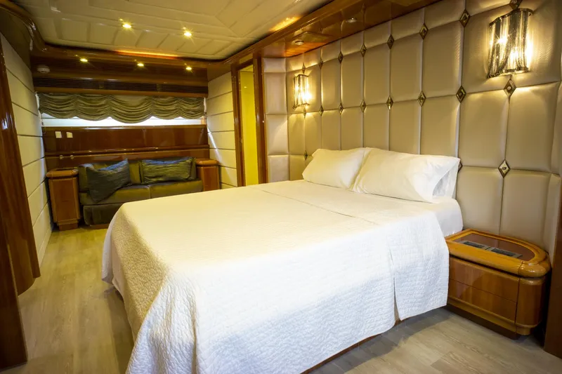 Paladin Yacht Photos Pics Luxurious bedroom interior on 2000 Ferretti Yachts Custom Line 94, featuring elegant wood and plush decor.