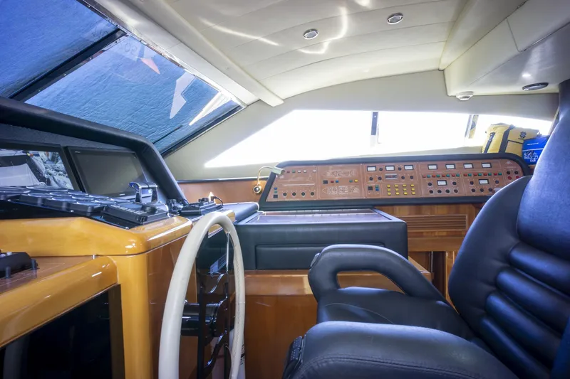 Paladin Yacht Photos Pics Interior helm of 2000 Ferretti Yachts Custom Line 94, featuring leather seating and control panel.