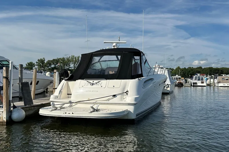 Navion Yacht Photos Pics 2001 Sea Ray 510 Sundancer yacht docked at marina under blue sky.
