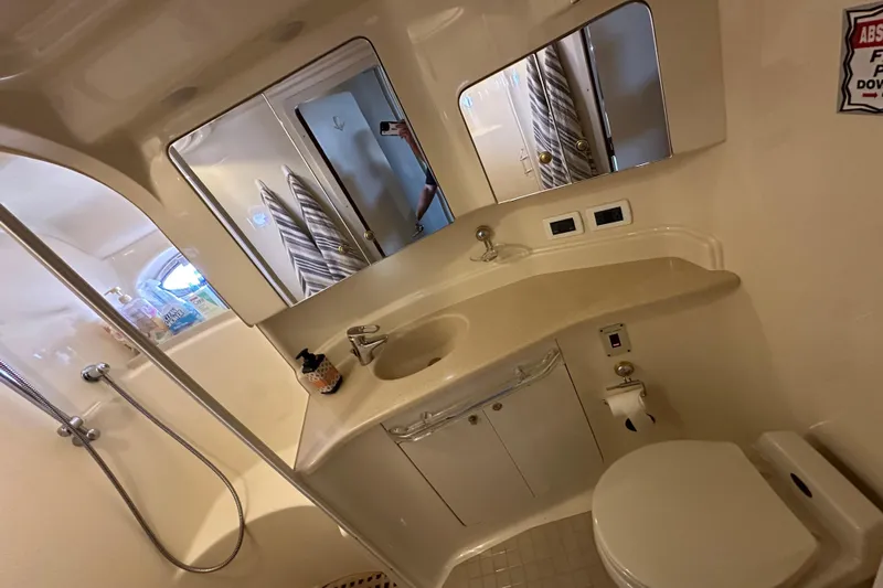Navion Yacht Photos Pics Bathroom interior of 2001 Sea Ray 510 Sundancer yacht, featuring sink, toilet, and shower.