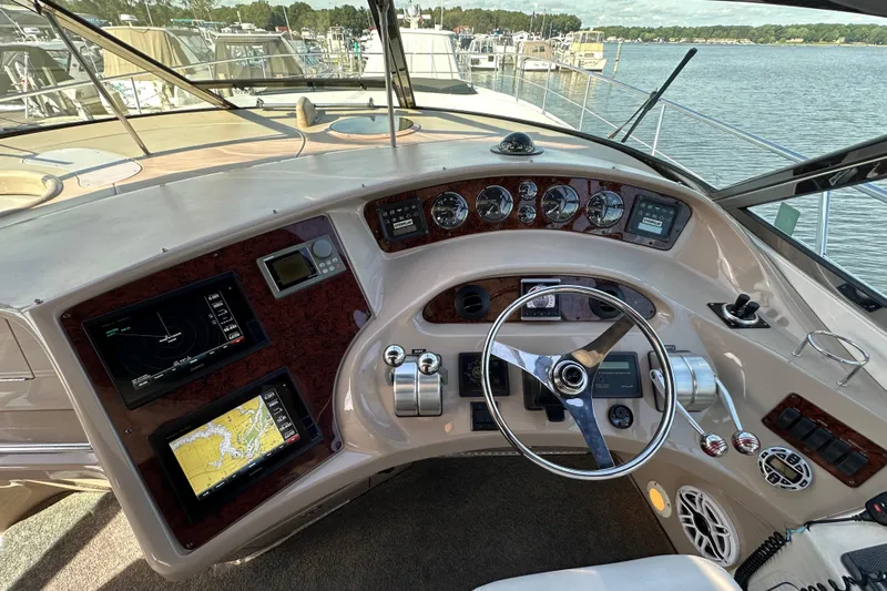 Navion Yacht Photos Pics Cockpit of 2001 Sea Ray 510 Sundancer with navigation displays and steering wheel.