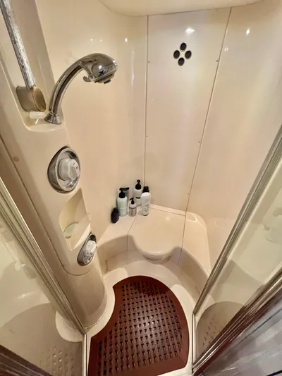 Bad Decisions Yacht Photos Pics Shower area in 2004 Azimut 55E yacht with modern fixtures and wooden floor mat.