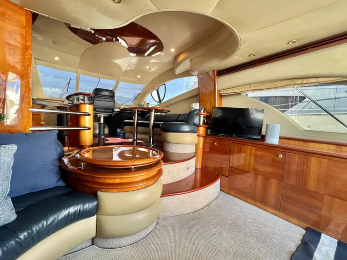 Bad Decisions Yacht Photos Pics Luxurious interior of a 2004 Azimut 55E yacht with elegant wood finishes and modern amenities.