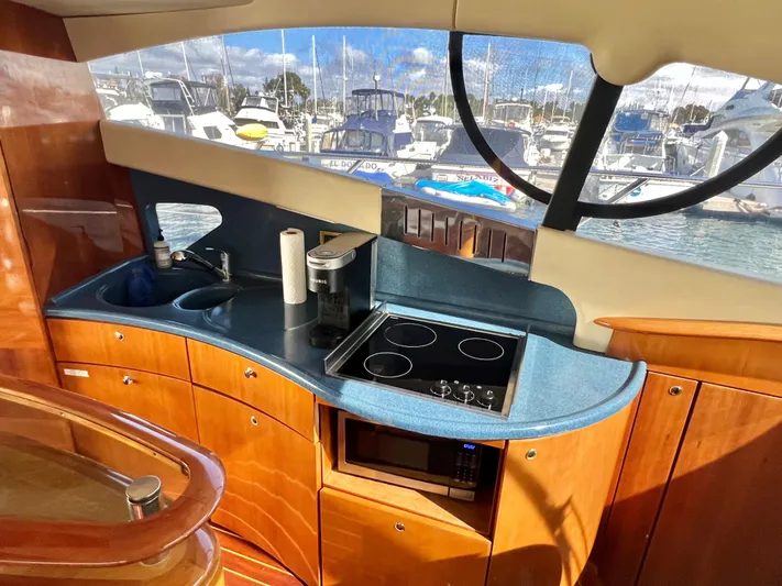 Bad Decisions Yacht Photos Pics 2004 Azimut 55E yacht kitchen with modern appliances and marina view.