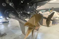 Close-up of 2008 SACS Strider boat propeller and drive system in a workshop.