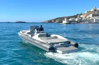 2008 SACS Strider boat cruising near a coastal lighthouse and scenic town.