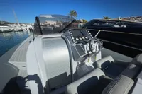 Cockpit of 2008 SACS Strider boat with modern controls, docked in a sunny marina.