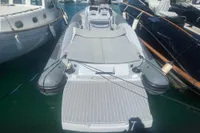 2008 SACS Strider boat docked between other vessels in a marina.